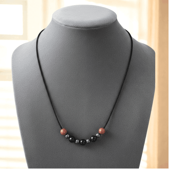 Minimalist Spiritual Protection Necklace featuring natural stones on a black cord for tranquil energy