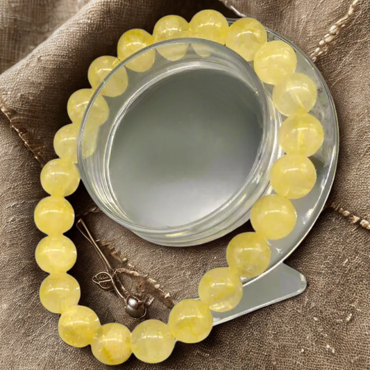 Natural Citrine Gemstone Bracelet for Power and Abundance displayed on a glass stand