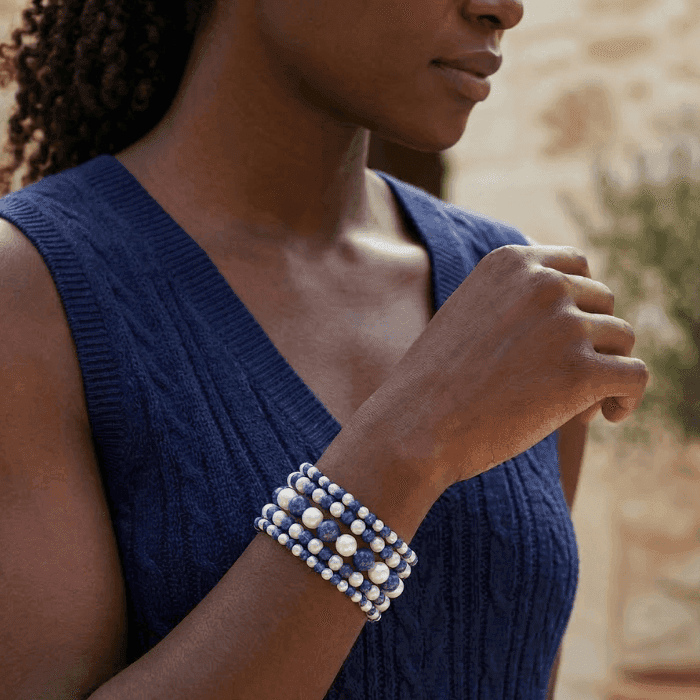 5 Strand Royal Blue and White Pearl Bracelet worn by a woman in a blue sweater