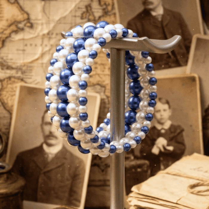 5-Strand Royal Blue and White Pearl Stretch Bracelet displayed elegantly on a stand