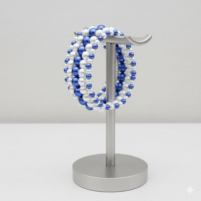 5-Strand Royal Blue and White Pearl Stretch Bracelet displayed on a silver stand for elegant accessory styling