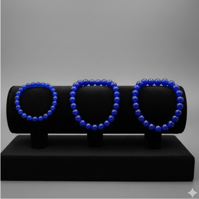 Three Blue Jade Friendship Bracelets displayed on a black showcase for stylish accessorizing