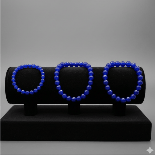 Three Blue Jade Friendship Bracelets displayed on a black showcase for stylish accessorizing