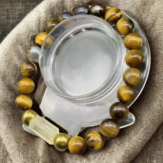 Boss Bracelet Genuine Tiger Eye and Citrine with polished beads on a textured fabric background