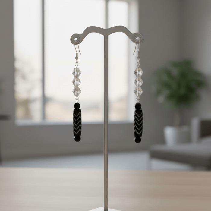 Cascade Crystal Wood Earrings featuring clear beads and black accents on a display stand