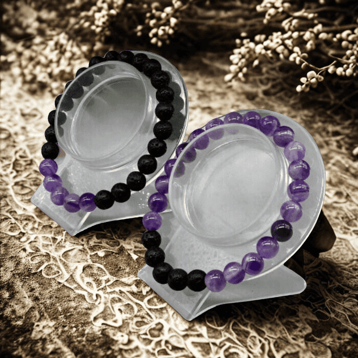 Crown Chakra Bracelets in purple and black beads displayed on stands for spiritual healing and style