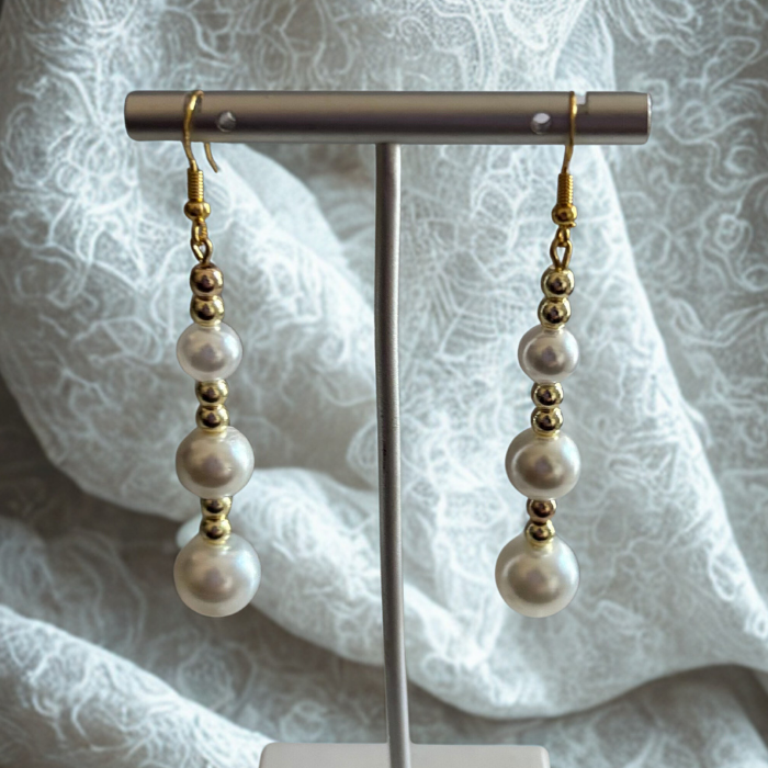 Elegant Hematite and Glass Pearl Drop Earrings by Peace N Beads Design displayed on a stand with white lace background