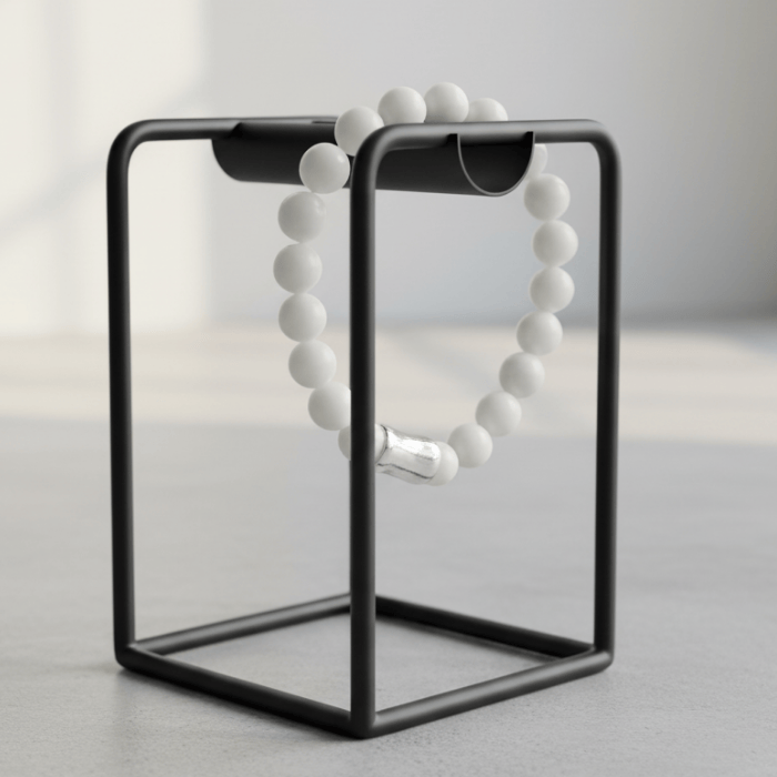 Elegant White and Blue Jade Gemstone Bracelet Set displayed on a modern black stand
