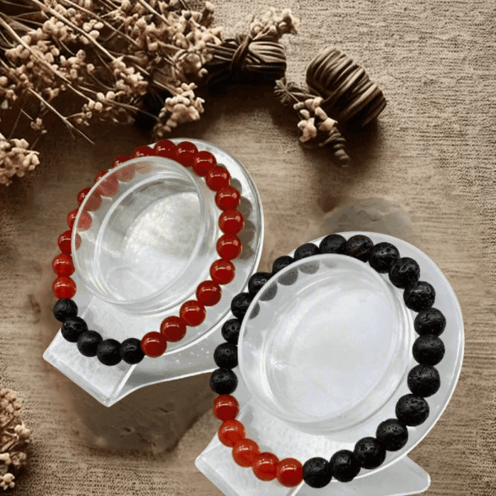 Energy Balancing Bracelets Root Chakra featuring red agate and black lava stones on display