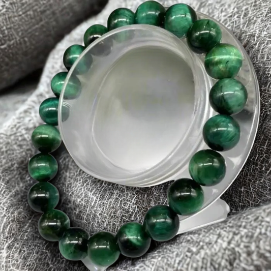 Genuine Green Tiger Eye Motivational Bracelet displayed on a clear stand highlighting its vibrant green beads