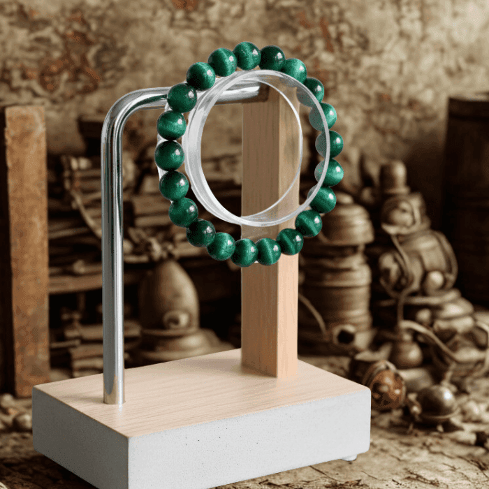 Genuine Green Tiger Eye Motivational Bracelet displayed on a modern stand with a rustic background