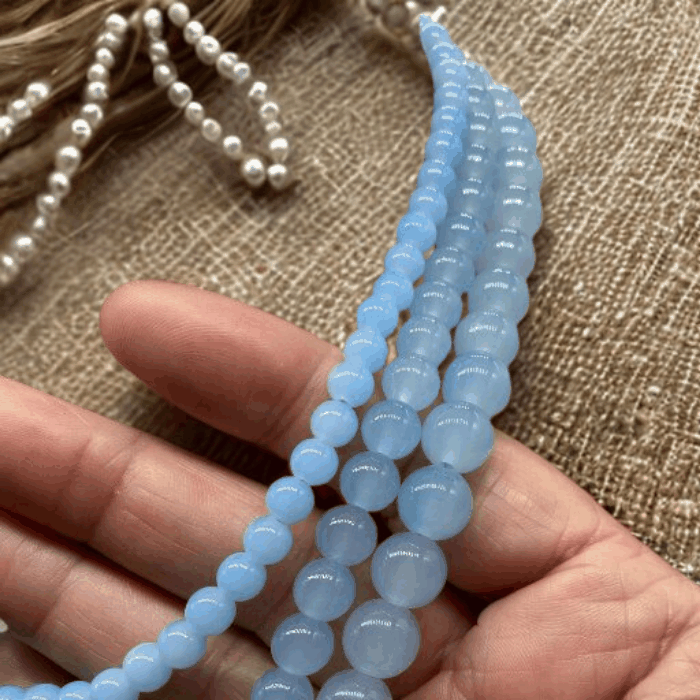 Handmade Blue Glass Bead Necklace by Peace N Beads with smooth round beads held in hand