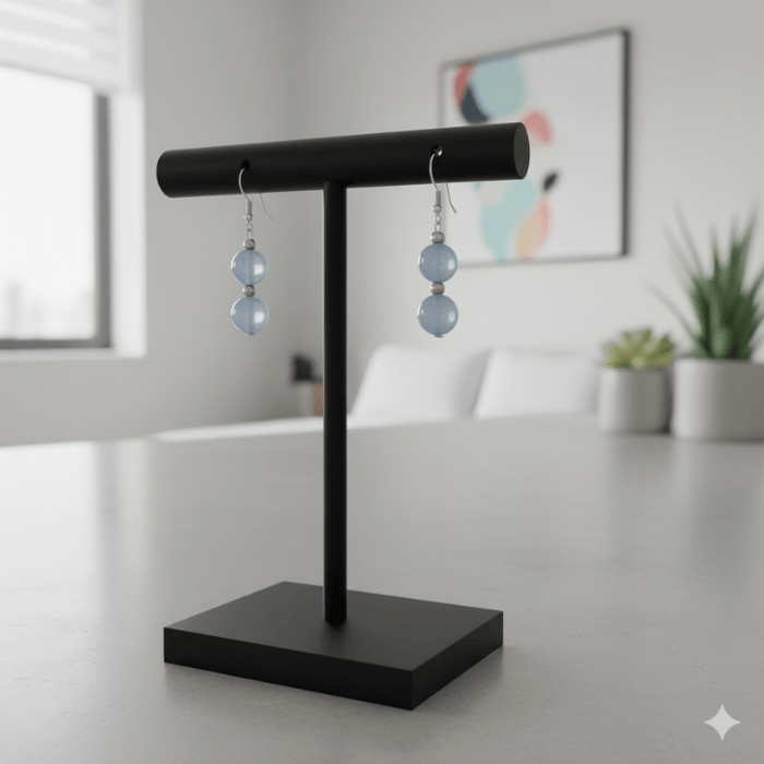 Handmade Light Blue Glass Beads Earrings Displayed on a Black Stand in a Modern Setting