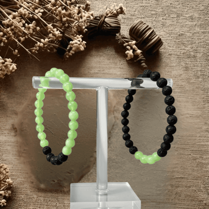 Heart Chakra Bracelets displayed on a stand with green and black beads for healing energy