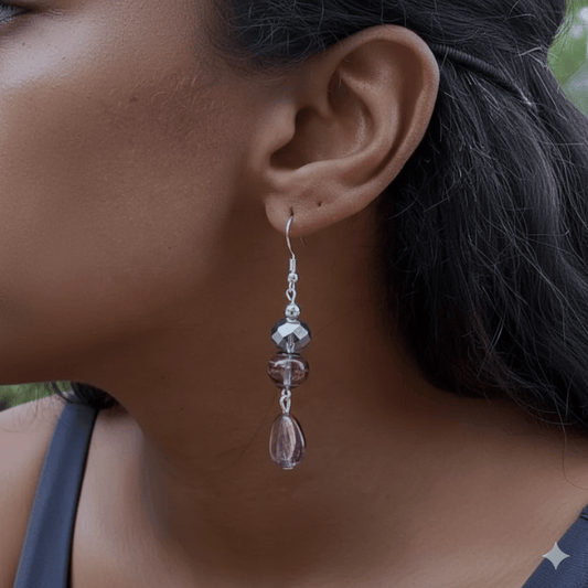 Elegant Lavender Blue Crystal and Glass Earrings dangling beautifully on a model's ear