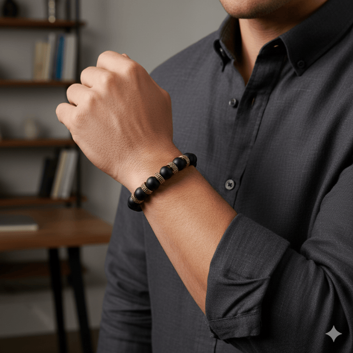 Luxurious Black and Gold Gemstone Bracelet worn by a man with a stylish outfit