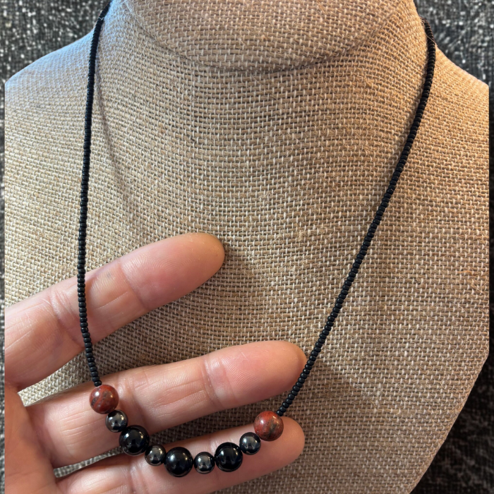 Minimalist Spiritual Protection Necklace featuring natural stones on a black cord for everyday wear
