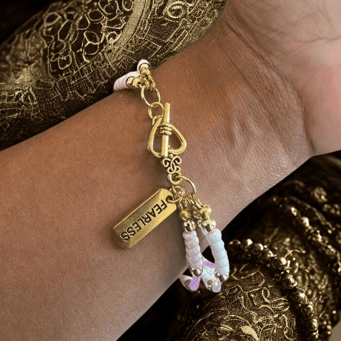 Close-up of a Pink Fearless Wrap Bracelet showcasing its elegant beads and gold accents