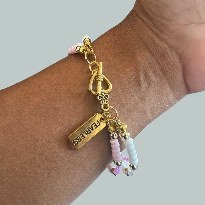 Pink Fearless Wrap Bracelet featuring gold accents and colorful beads for a stylish look