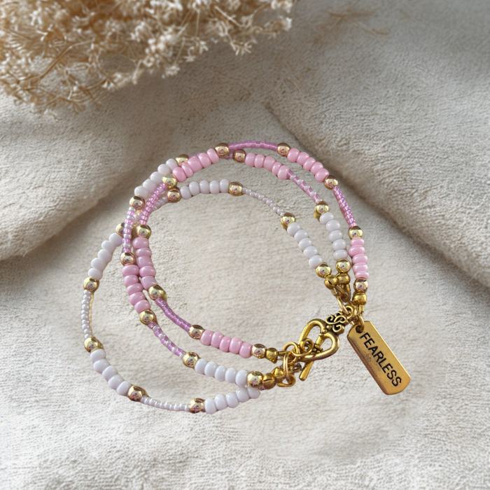 Pink Fearless Wrap Bracelet featuring pastel beads and a gold accent tag for stylish accessories