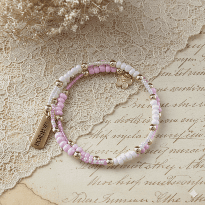 Pink Warrior Wrap Bracelet featuring pastel beads and gold accents for a stylish accessory