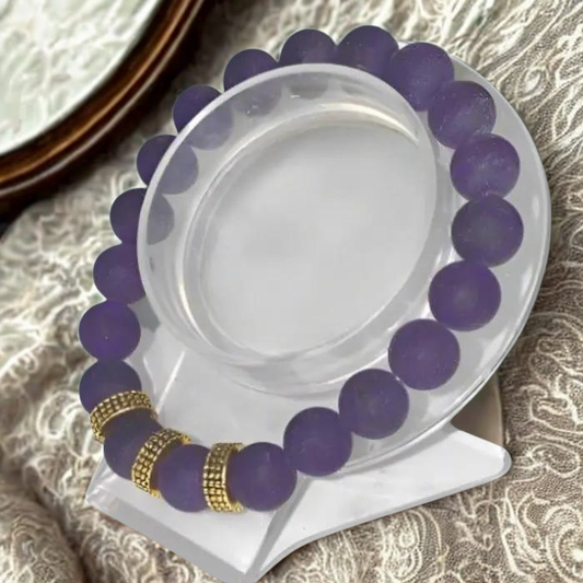 Peace N Beads Purple Reigns Supreme Purple Jade Gold Accent Bracelet displayed on a clear stand