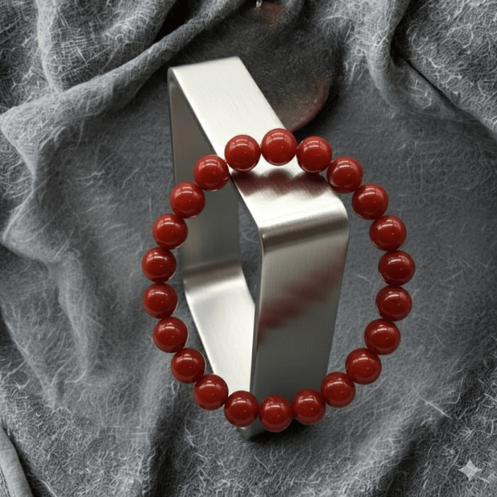 Red Coral and Cream Fossil Bracelet Set featuring smooth red coral beads on a silver display