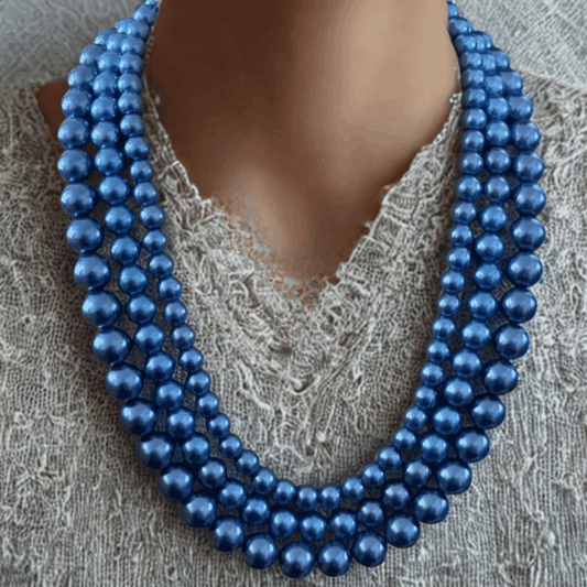 Peace N Beads Regal Three-Layer Royal Blue Pearl Necklace with glossy round beads on a textured fabric background