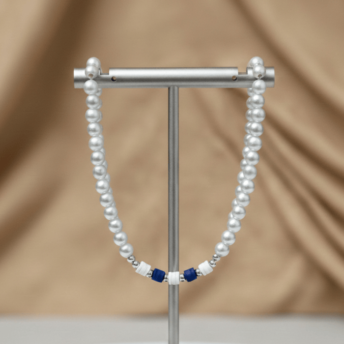 Elegant Royal Blue and White Jewelry Set with Pearl Beads displayed on a silver rack