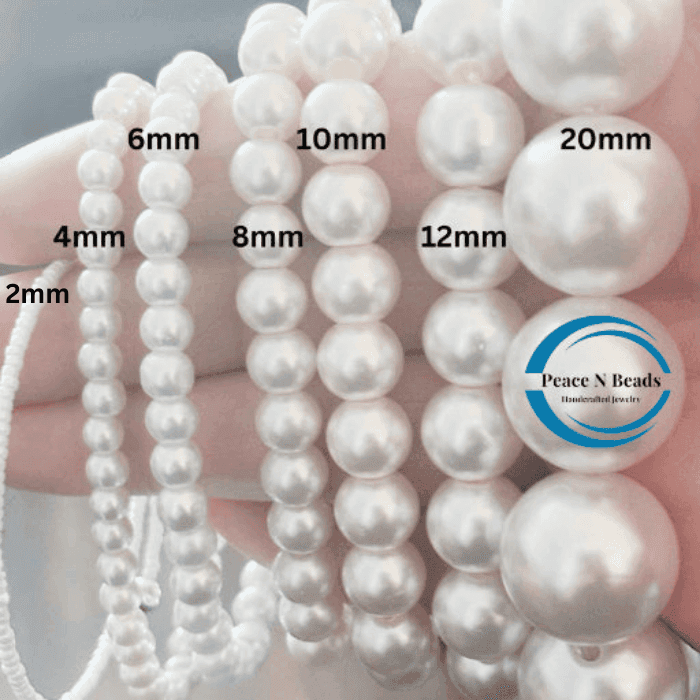 Close-up of varying sizes of glass pearl beads from Peace N Beads for the Sapphire Sparkle Rhinestone Bead and Glass Pearl Necklace