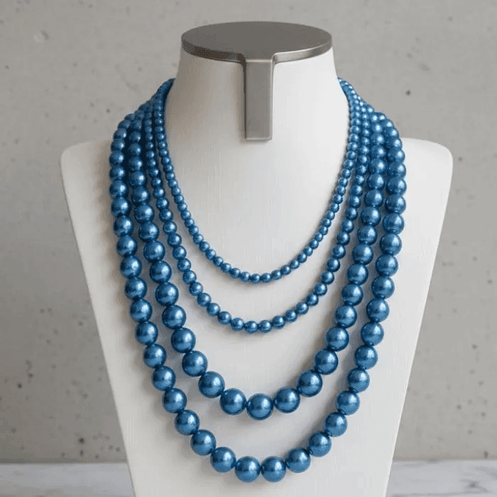 Single Strand Blue Glass Pearl Necklace with a Elegant Shine on a Display Mannequin