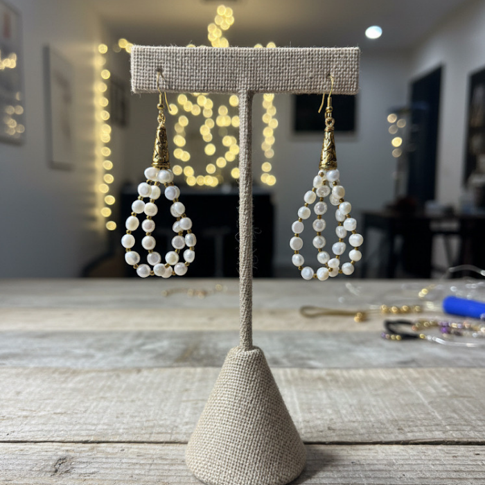 Small Oval Freshwater Pearl Drop Earrings on display with elegant gold accents for a chic look