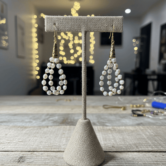 Small Oval Freshwater Pearl Drop Earrings on display with elegant gold accents for a chic look