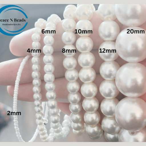 Collection of white pearls in various sizes showcasing a Spiritual Gemstone Jewelry Set from Peace N Beads