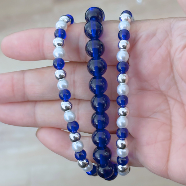3 Strand Royal Blue White and Silver Bracelet with round beads held in hand by Peace N Beads