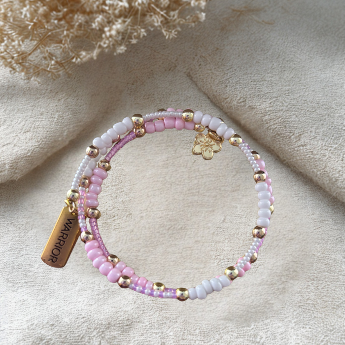 Pink Warrior Wrap Bracelet with pastel beads and gold accents, perfect for any outfit