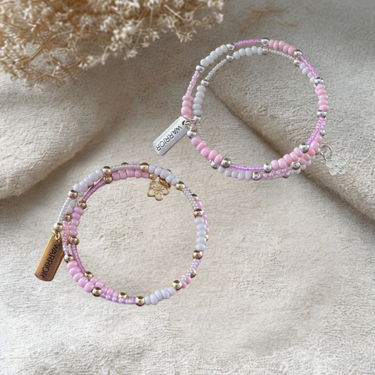 Pink Warrior Wrap Bracelet featuring vibrant beads and a delicate charm for stylish accessorizing.