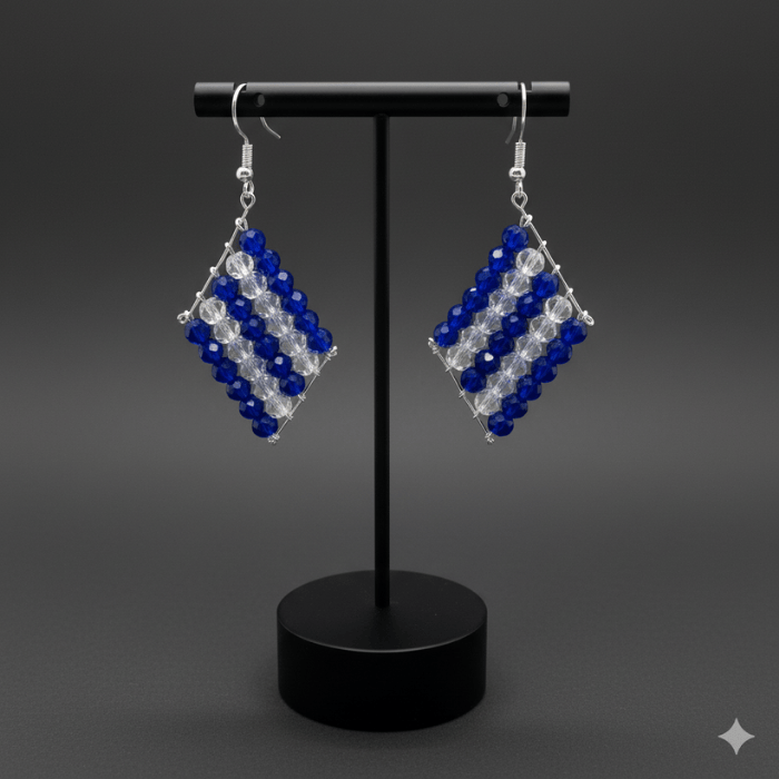 Royal Blue and Clear Crystal Drop Earrings on a display stand showcasing elegant design