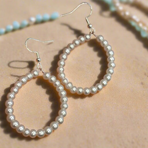 Elegant Small Pearl Oval Hoop Earrings featuring a delicate design, perfect for adding a touch of sophistication to any outfit