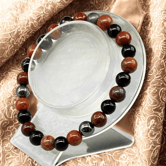 Beautiful Spiritual Protection Gemstone Bracelet featuring black and red stones on a display stand