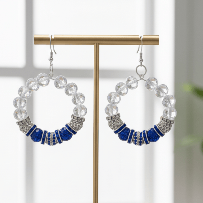 Stunning Beaded Hoop Earrings featuring clear and blue beads with silver accents on a display stand
