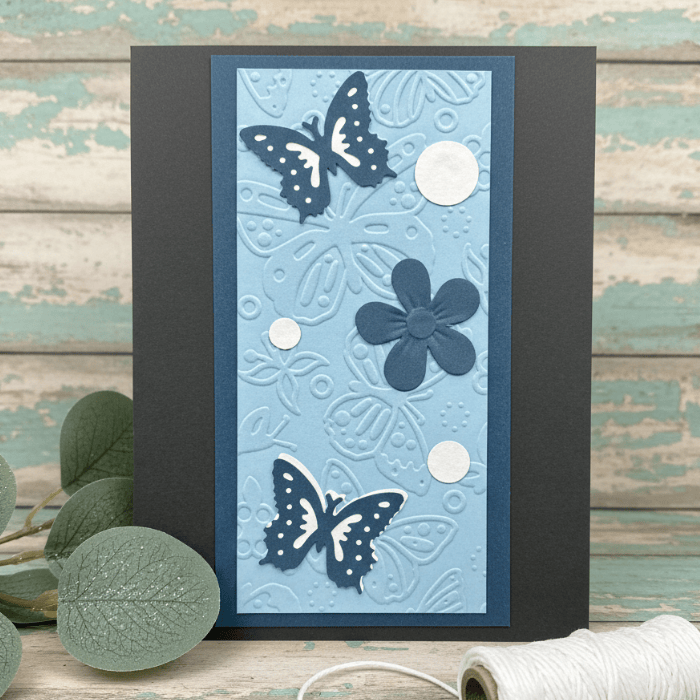 Where Flowers and Wings Unfold Note Cards featuring embossed butterflies and a flower on blue cardstock