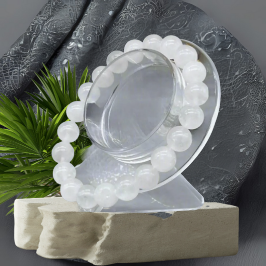 Elegant White Jade Gemstone Bracelet displayed on a clear stand with a textured background