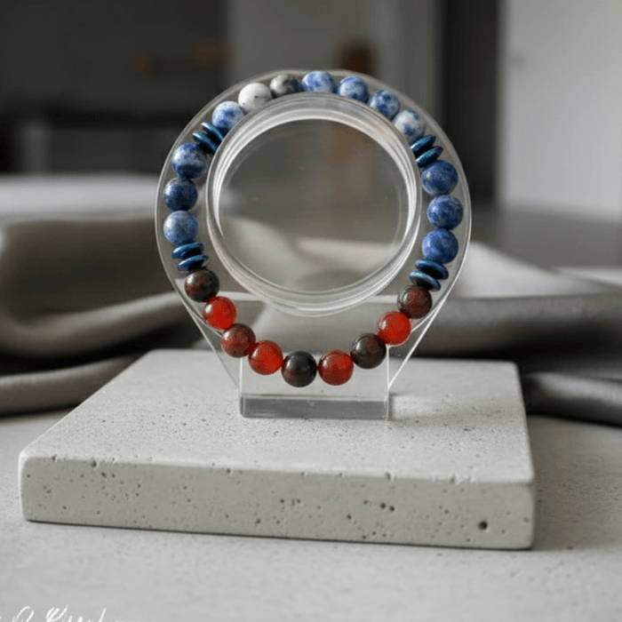 Writers Gemstone Bracelet with colorful beads in blue, red, and green, showcased on a display stand